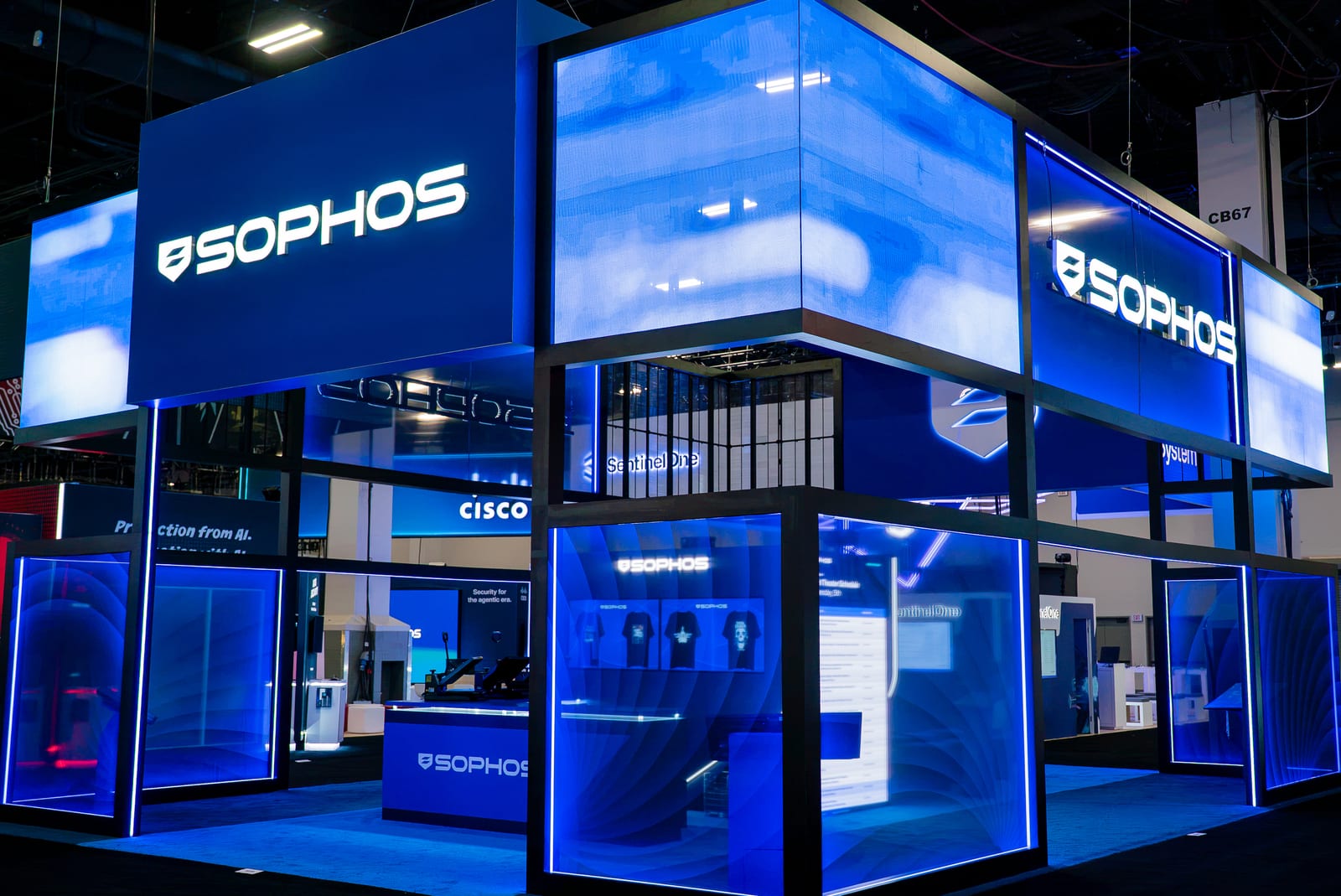 The two-level Sophos booth at Black Hat 2026, every face of the upper deck glowing blue with LED