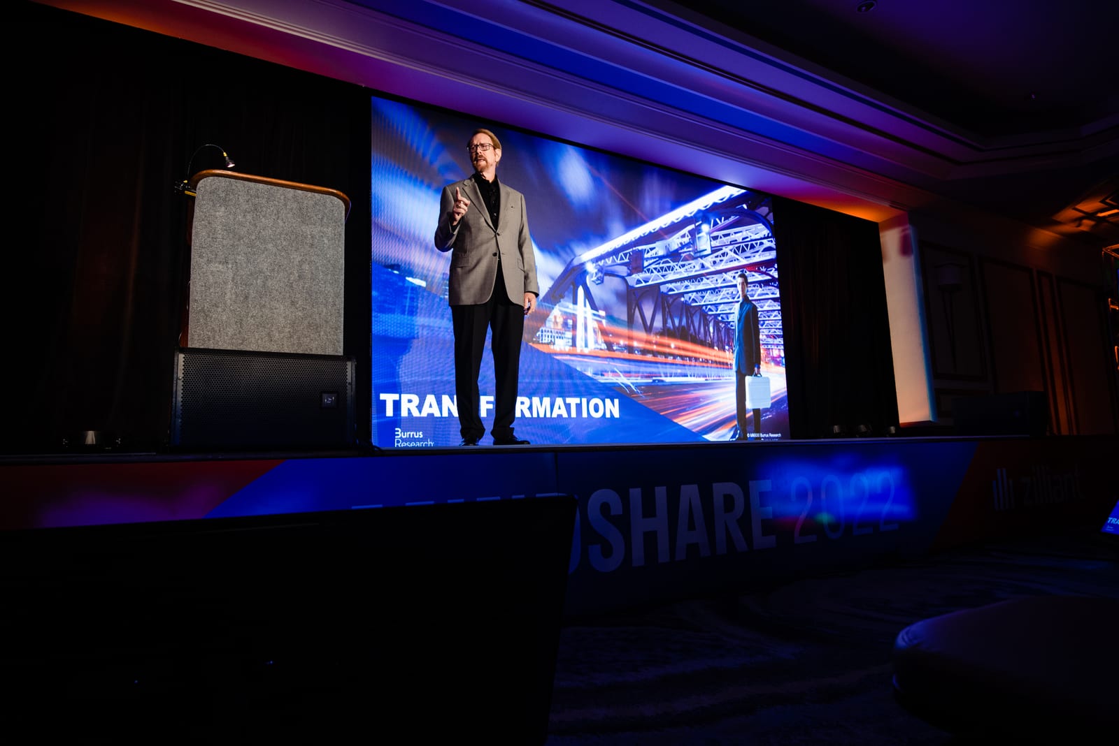 A presenter on the Mindshare 2022 general-session stage in front of a wide LED wall, with Mindshare 2022 and the Zilliant logo on the stage front